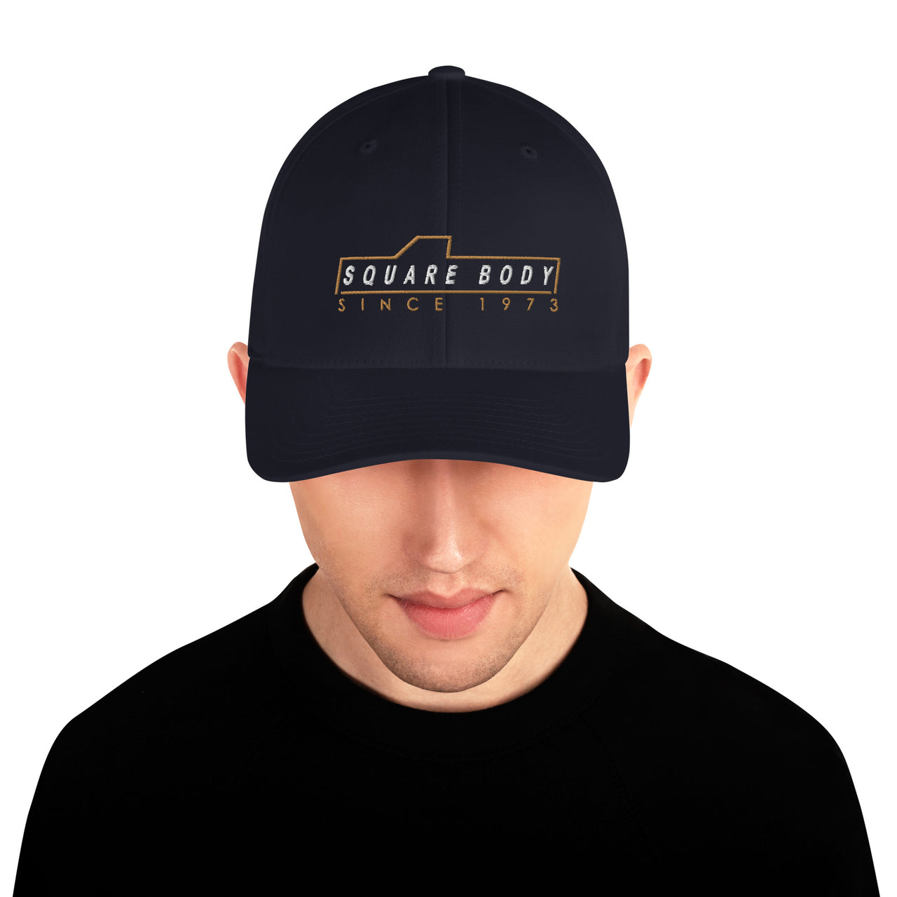 man wearing a square body sice 1973 hat from aggressive thread in navy