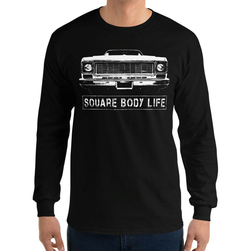 Man wearing a 73-75 Square Body Long Sleeve Shirt in black from Aggressive Thread