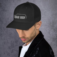 Thumbnail for man wearing a 3/4 view of a square body suburban trucker hat from aggressive thread in black