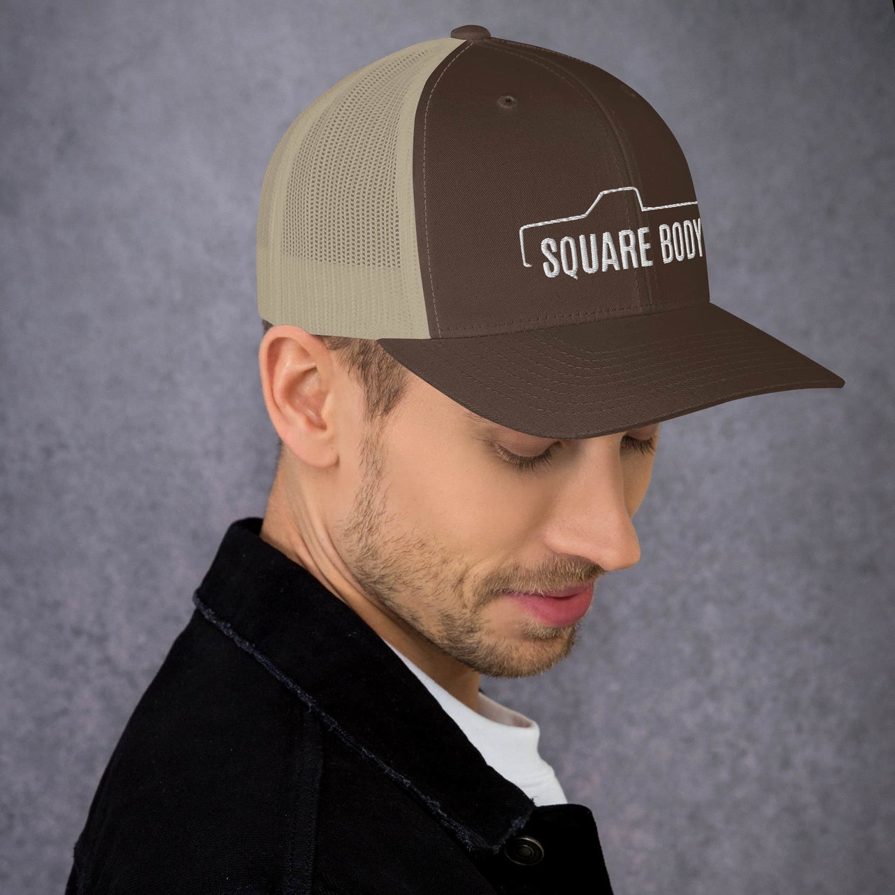 man wearing a Square body c10 k10 trucker hat from aggressive thread in brown